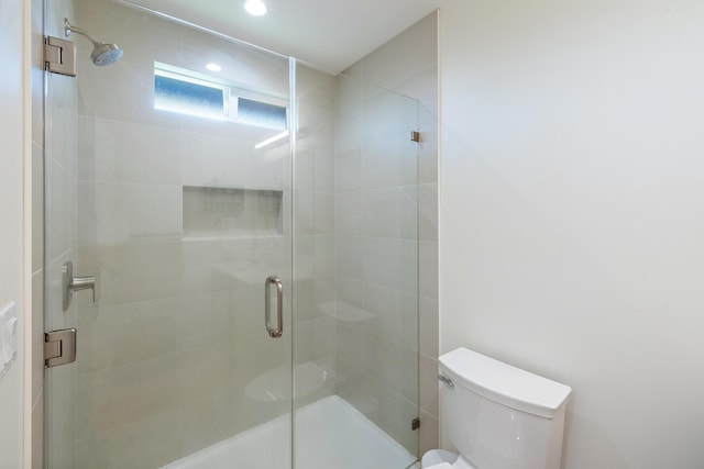 bathroom with walk in shower and toilet