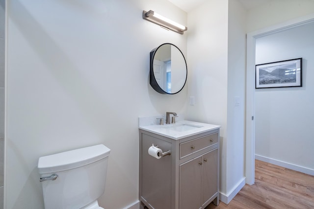 bathroom featuring hardwood / wood-style flooring, vanity, and toilet