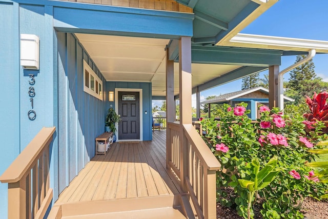 view of exterior entry featuring covered porch