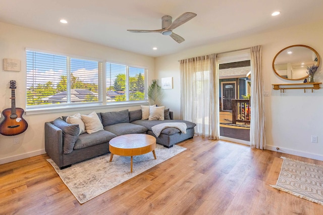 living room featuring ceiling fan and light wood-type flooring