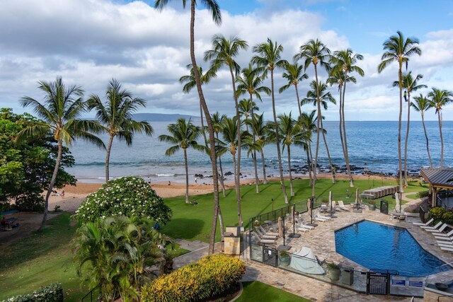 view of pool featuring a patio area, a water view, and a view of the beach