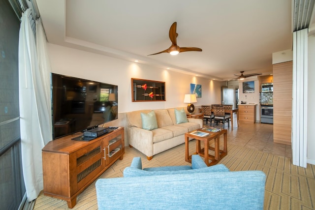 living room featuring ceiling fan and light tile patterned flooring