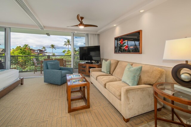 living room featuring expansive windows and ceiling fan