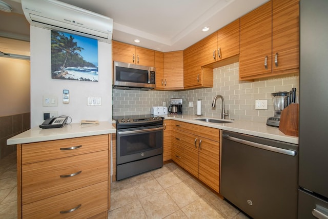 kitchen with an AC wall unit, sink, backsplash, stainless steel appliances, and light tile patterned flooring