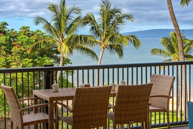 wooden deck featuring a water and mountain view