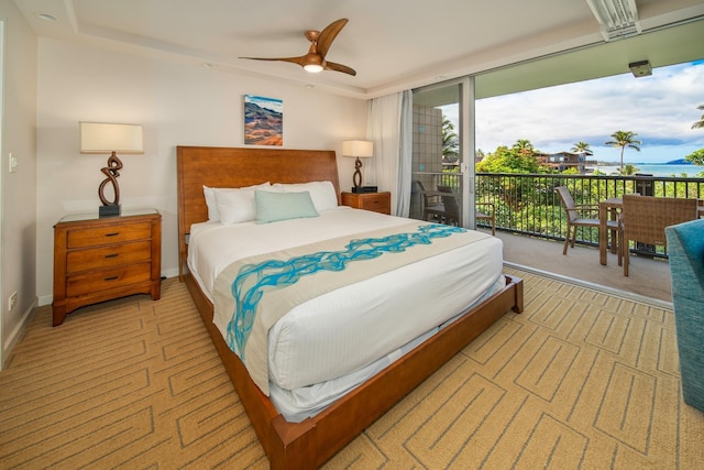 bedroom with light carpet, access to exterior, and ceiling fan