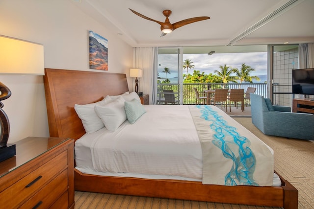 bedroom featuring light carpet, expansive windows, ceiling fan, and access to outside