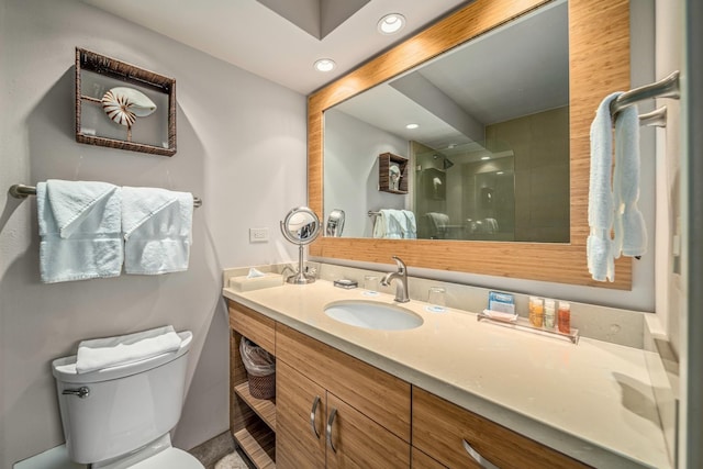 bathroom with a shower with door, toilet, and vanity