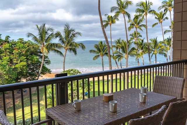 wooden deck featuring a lawn and a water view