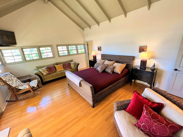 bedroom with high vaulted ceiling, light hardwood / wood-style flooring, and beamed ceiling