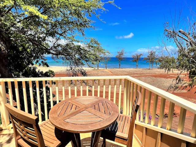 wooden deck with a view of the beach and a water view