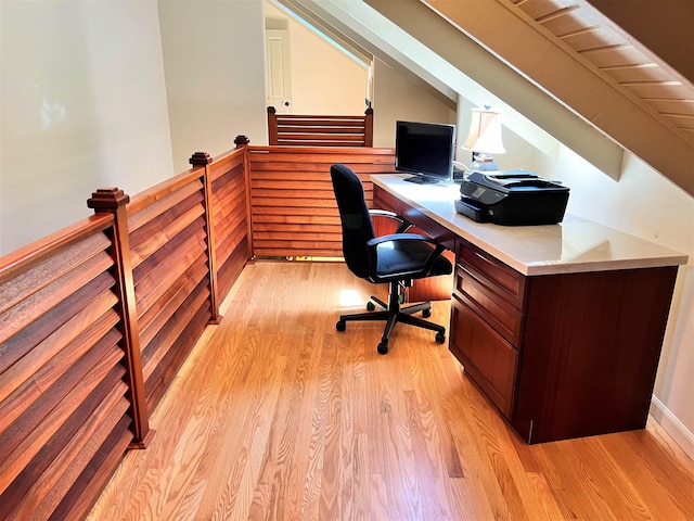 office area with light wood-type flooring and lofted ceiling