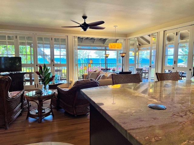 interior space featuring stone counters, ceiling fan, and french doors