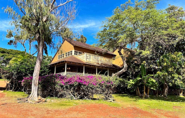 back of property with a balcony