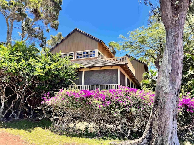 view of side of property featuring a sunroom