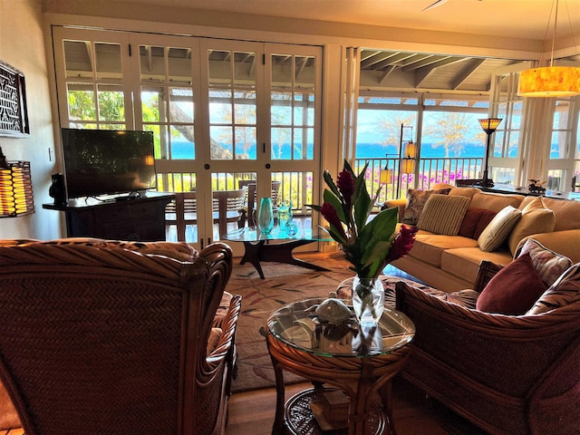 living room with beamed ceiling and french doors