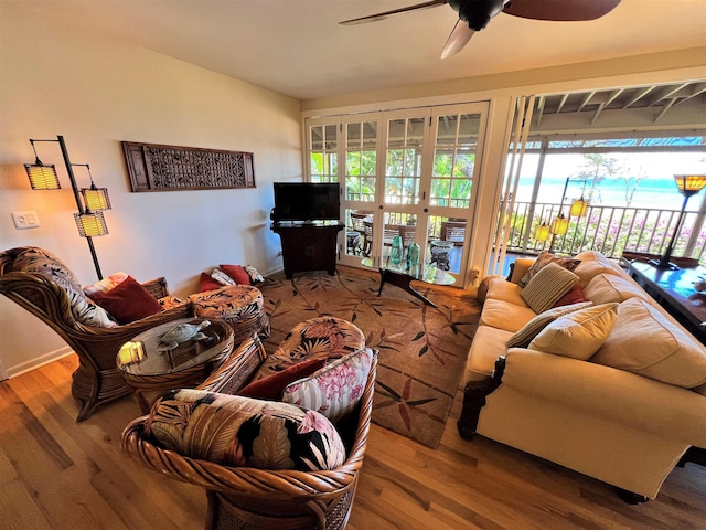 living room featuring ceiling fan and hardwood / wood-style flooring