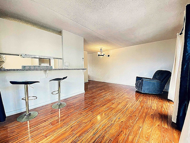 unfurnished room with light hardwood / wood-style floors and a textured ceiling