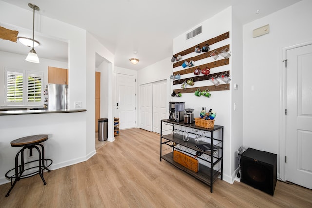 hallway with light hardwood / wood-style flooring