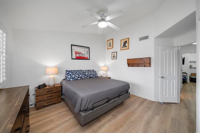 bedroom featuring lofted ceiling, light hardwood / wood-style floors, and ceiling fan