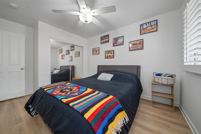 bedroom with light hardwood / wood-style floors, a closet, and ceiling fan