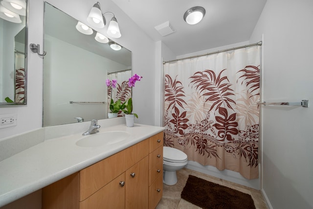 bathroom with vanity, toilet, and tile patterned flooring