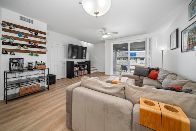 living room with hardwood / wood-style flooring and ceiling fan