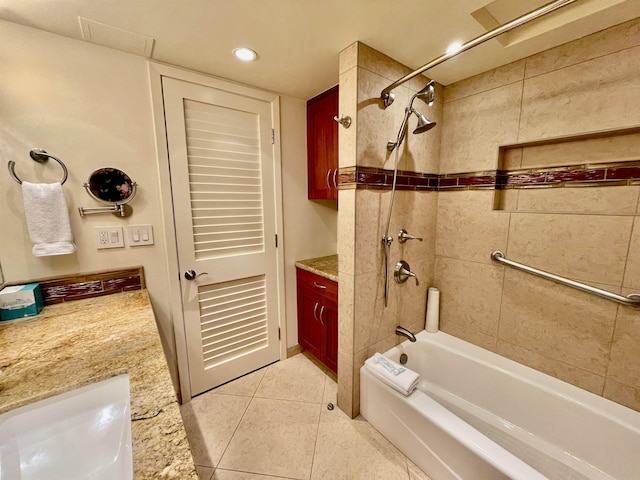 bathroom with tiled shower / bath combo, tile patterned floors, and vanity