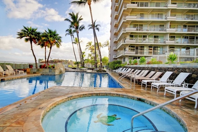 view of swimming pool featuring a patio area and a hot tub