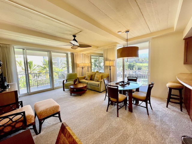 dining space with light carpet, ceiling fan, and wood ceiling