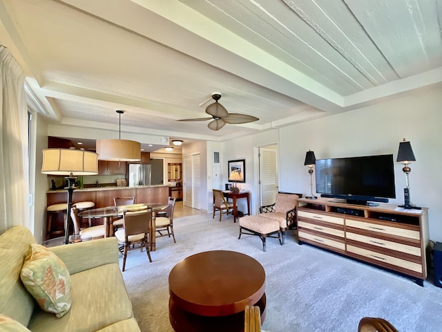 carpeted living room with ceiling fan