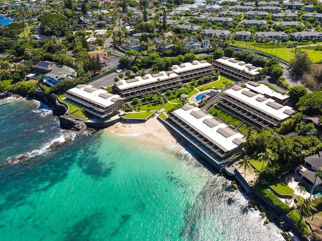 drone / aerial view with a water view and a beach view