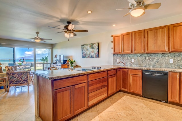 kitchen featuring kitchen peninsula, decorative backsplash, ceiling fan, and black appliances