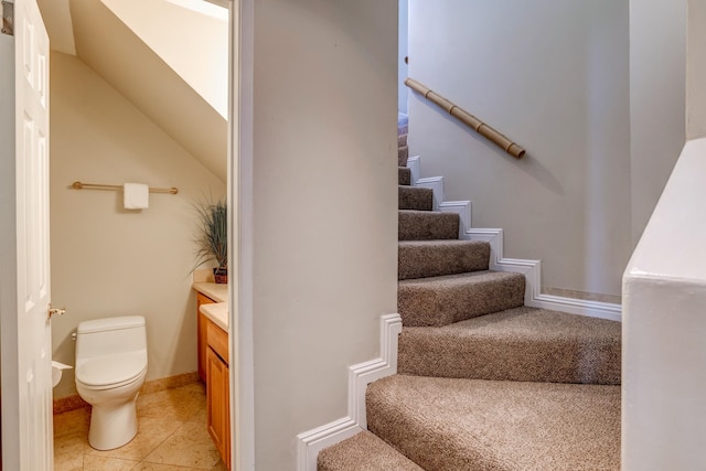 stairs featuring tile patterned flooring