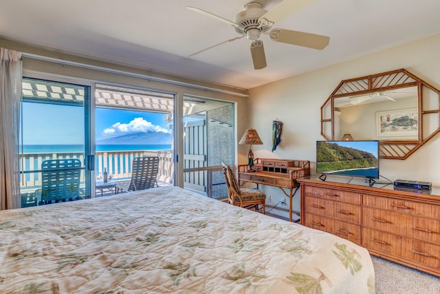 bedroom featuring carpet, ceiling fan, a water view, and access to outside