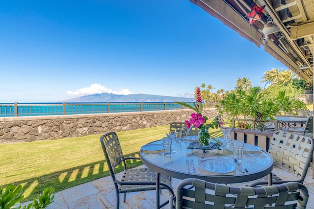 view of patio / terrace with a water and mountain view