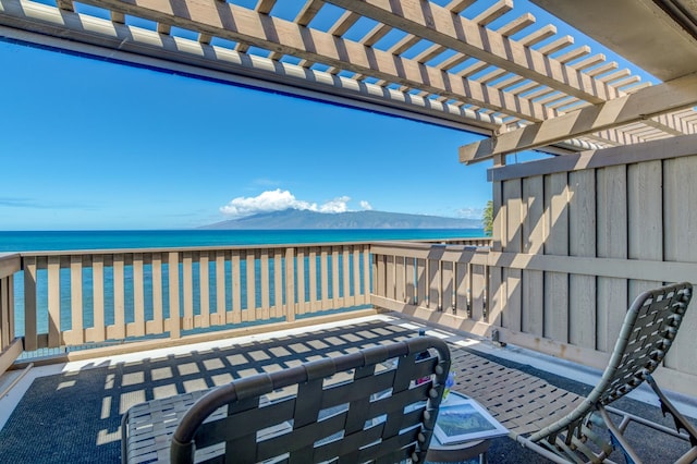 view of patio / terrace featuring a pergola and a water view