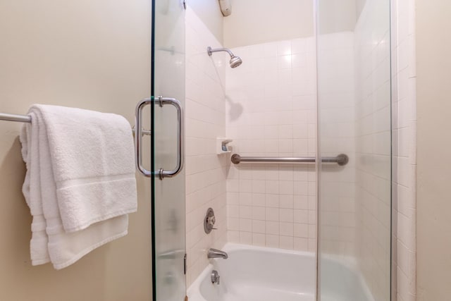 bathroom with shower / bath combination with glass door