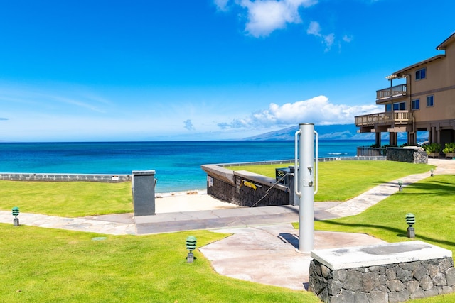 view of property's community with a water view and a yard