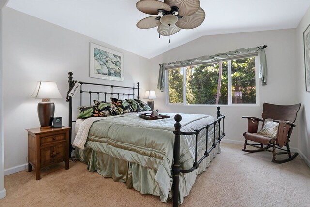 bedroom featuring light colored carpet, baseboards, lofted ceiling, and ceiling fan