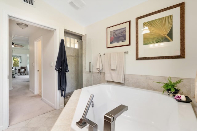 bathroom with visible vents, a bath, a shower stall, and tile patterned flooring