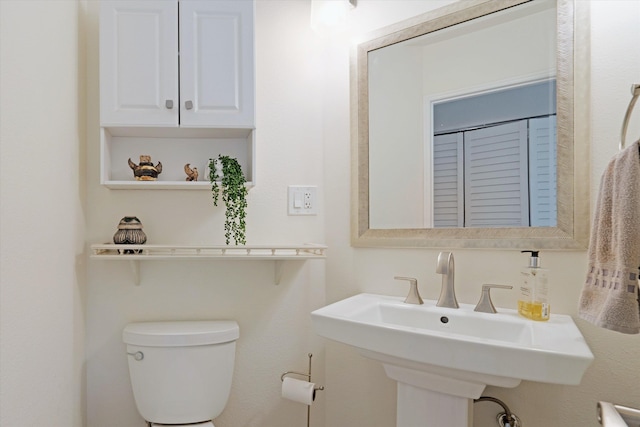 bathroom with toilet and a sink