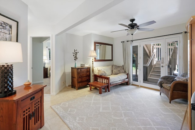 living area with stairway, light tile patterned floors, a ceiling fan, and baseboards