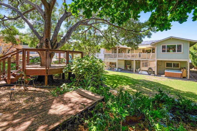 view of yard featuring a patio, a hot tub, and a deck