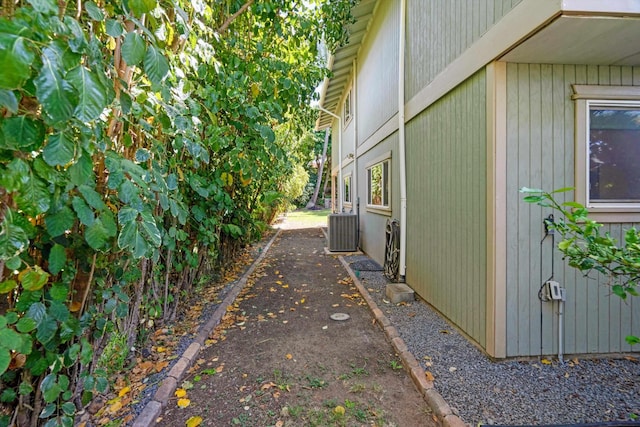 view of side of home with central AC unit