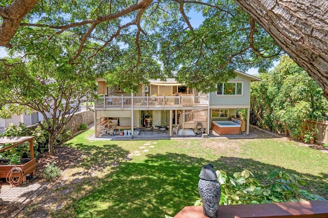 back of property with a yard, a patio, a fenced backyard, and a hot tub