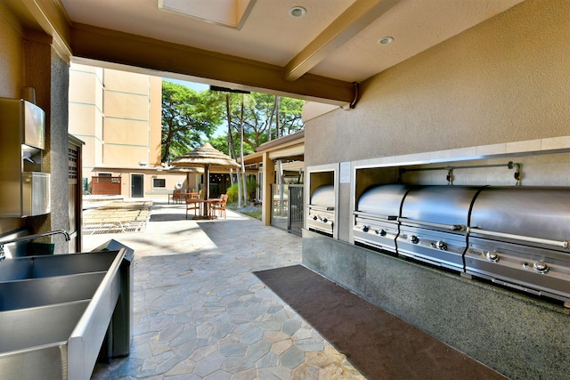 110 Kaanapali Shores Pl Unit 817, Lahaina, HI 96761 - view of patio / terrace with area for grilling, a sink, and outdoor dining area