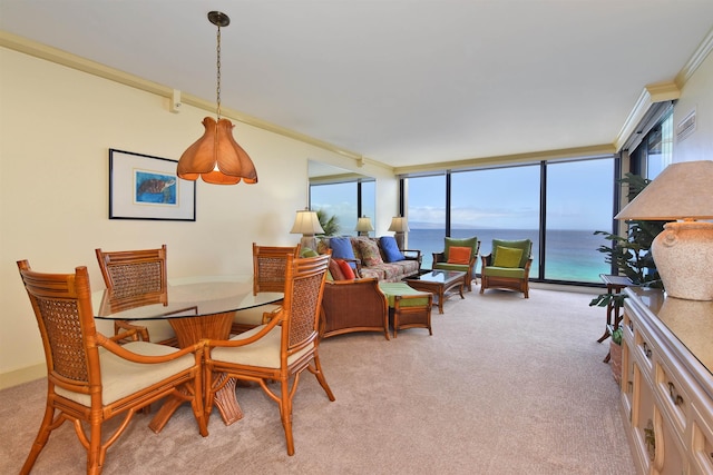 110 Kaanapali Shores Pl Unit 817, Lahaina, HI 96761 - dining room featuring healthy amount of natural light, light colored carpet, ornamental molding, and a water view