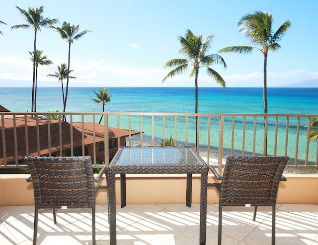 balcony with a patio area and a water view