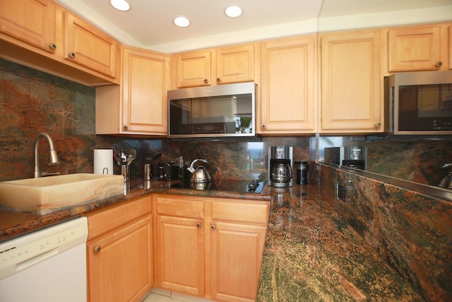 kitchen with light brown cabinets, sink, decorative backsplash, and dishwasher